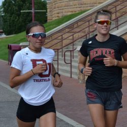 Two athletes from the DU Triathlon Team run on campus.