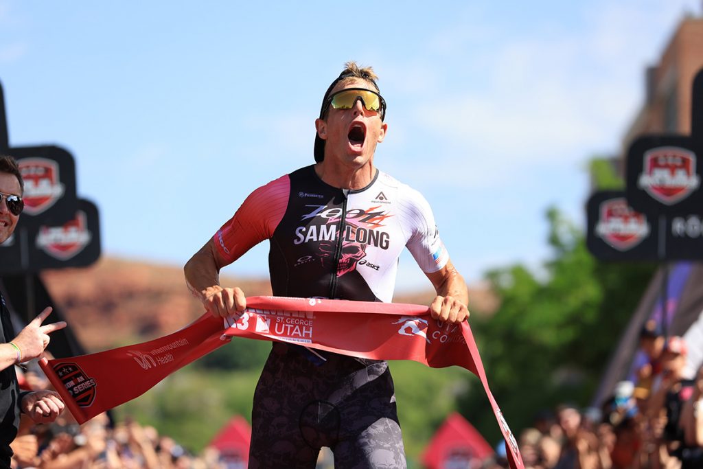 Sam Long celebrates after breaking the finish line tape